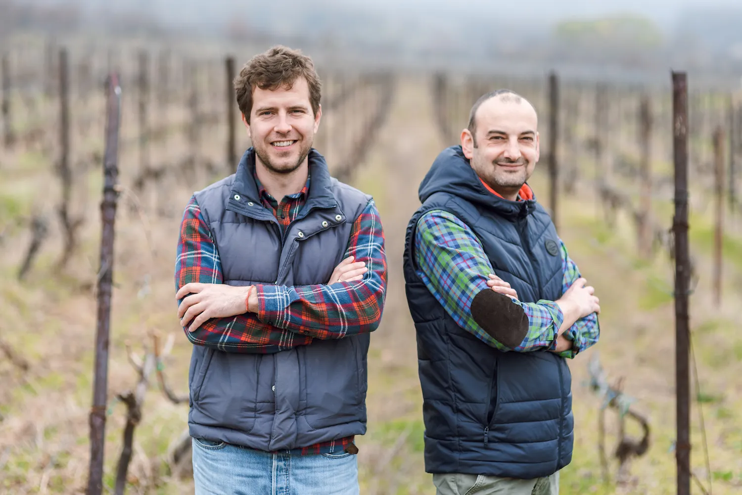 Petar Georgiev & Radostin Milkov standing in a vineyard.
